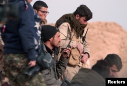 FILE - Syrian Democratic Forces (SDF) fighters gather during an offensive against Islamic State militants in northern Raqqa province, Syria Feb. 8, 2017.