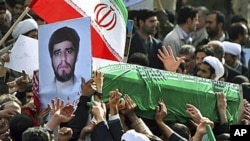 Pro-government Iranians carry the flag-draped coffin of Sane Jaleh, seen in picture at left, a student who was killed during Monday's clashes, in a funeral ceremony in Tehran, Iran, February 16, 2011