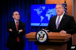 Elliott Abrams, left, listens to Secretary of State Mike Pompeo talk about Venezuela at the State Department in Washington, Jan. 25, 2019.
