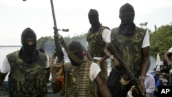 Members of Movement for the Emancipation for the Niger Delta, (MEND) a militant group patrol the creeks in the Niger Delta area of Nigeria, in this Feb. 24, 2006 file photo.