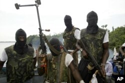 Members of Movement for the Emancipation for the Niger Delta, (MEND) a militant group patrol the creeks in the Niger Delta area of Nigeria, in this Feb. 24, 2006 file photo.