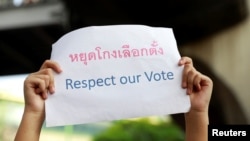 An activist holds a poster as she protests the election result in Bangkok, Thailand, March 31, 2019.