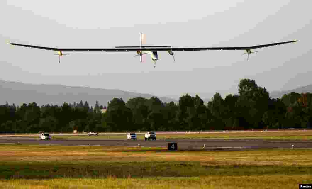 The Solar Impulse approaches the runway for a landing following a test flight at Moffett Field in Mountain View, California, USA. The aircraft, made of carbon fiber sheets and powered by solar cells, will attempt to fly once around the world powered solely by solar energy.