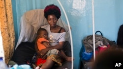 Ado Ntanga, 23, holds her son, Adrielle Nyembwe, 3, who was admitted to the Medicare Policlinic with Sickle Cell Anemia in Lubumbashi, Democratic Republic of the Congo.