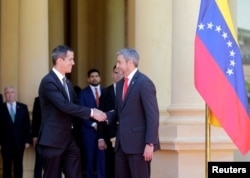 Paraguayan President Mario Abdo Benitez, right, and Venezuelan opposition leader Juan Guaido, who many nations have recognized as the country's rightful interim ruler, shake hands during a meeting at the Lopez Palace in Asuncion, Paraguay, March 1, 2019.