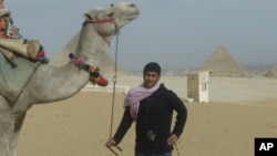 Mahmoud Adal and his camel await tourists in Giza, Egypt.