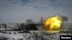 A Russian army service member fires a howitzer during drills at the Kuzminsky range in the southern Rostov region, Russia Jan. 26, 2022.