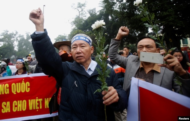 FILE - People take part in an anti-China protest to mark the 43th anniversary of the China's occupation of the Paracel Islands in the South China Sea in Hanoi, Jan. 19, 2017.