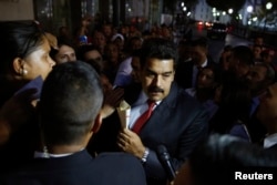 Venezuela's President Nicolas Maduro (C) greets supporters after his meeting with representatives of the Venezuelan coalition of opposition parties Mesa de la Unidad (MUD) and the Union of South American Nations' foreign ministers in Caracas, April 8, 2014.