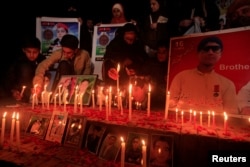 People light candles to remember the victims of an attack on the Army Public School in 2014. The candlelight vigil was held in Peshawar, Pakistan, Dec. 15, 2016.