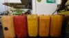 FILE- A man fills containers with diesel at a Nigeria National Petroleum Corporation petrol station in Abuja, Nigeria, May. 26, 2015.