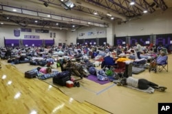 Evacuees shelter at River Ridge Middle/High School in preparation for Hurricane Milton in New Port Richey, Florida, Oct. 9, 2024.