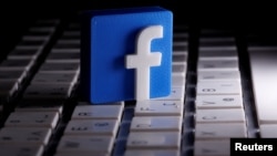 FILE - A 3D-printed Facebook logo is seen placed on a keyboard in this illustration taken March 25, 2020.