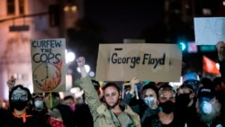 Demonstrators attend a "Sit Out the Curfew" protest against the death of George Floyd who died on May 25 in Minneapolis whilst in police custody, along a street in Oakland, California on June 3, 2020. - US protesters welcomed new charges against…