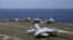 A U.S. Navy F-18 fighter jet lands on the deck of the USS Carl Vinson (CVN 70) aircraft carrier following a routine patrol off the disputed South China Sea, March 3, 2017. 