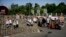 Egyptians walk between brick barricades erected along a street that leads to Rabaah al-Adawiya mosque, where supporters of Egypt's ousted President Mohammed Morsi have installed a camp and hold daily rallies at Nasr City, in Cairo, July 29, 2013.