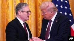 Britain's Prime Minister Keir Starmer and U.S. President Donald Trump shake hands at a joint press conference in the East Room at the White House, Feb. 27, 2025, in Washington.