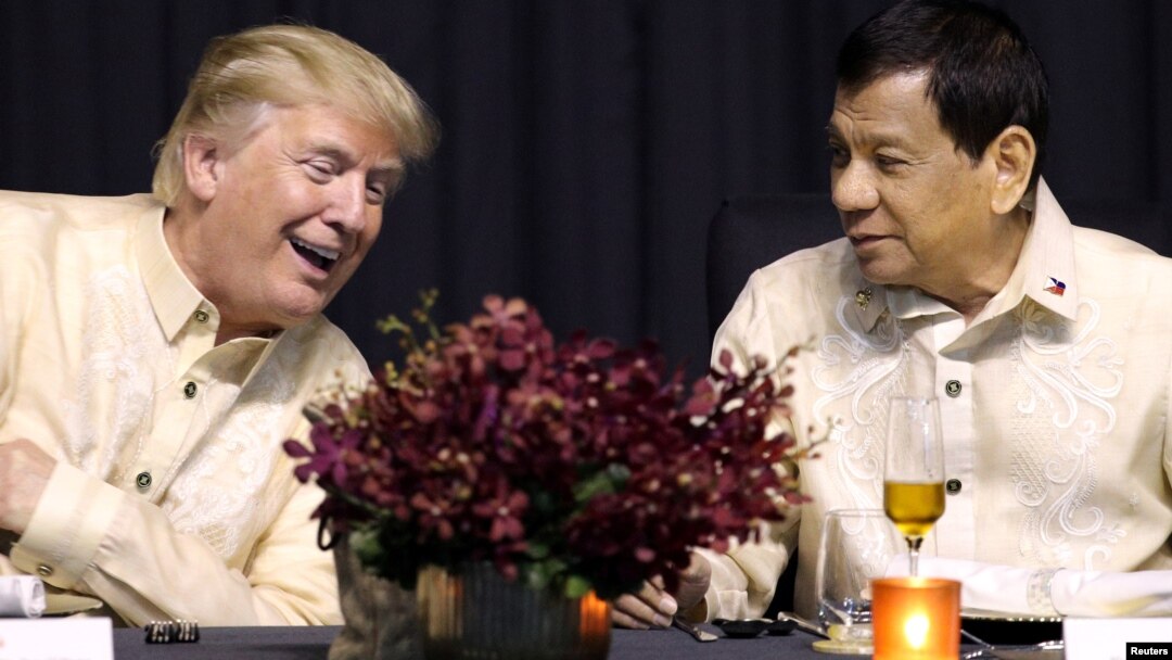 U.S. President Donald Trump speaks with Philippines President Rodrigo Duterte during the dinner marking ASEAN's 50th anniversary in Manila, Philippines, Nov. 12, 2017.
