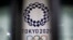 FILE - The logo of Tokyo 2020 Olympic Games, that have been postponed to 2021 due to the coronavirus outbreak, is seen through signboards, at Tokyo Metropolitan Government Office building in Tokyo, Japan, Jan. 22, 2021. 
