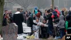 The mother of Maria Francesca, who died of sudden infant death syndrome, cries in front of the coffin of her baby during the funeral in Wissous, outside Paris, France, Monday, Jan. 5, 2015. Wissous offered a gravesite for the baby after the mayor of Champ