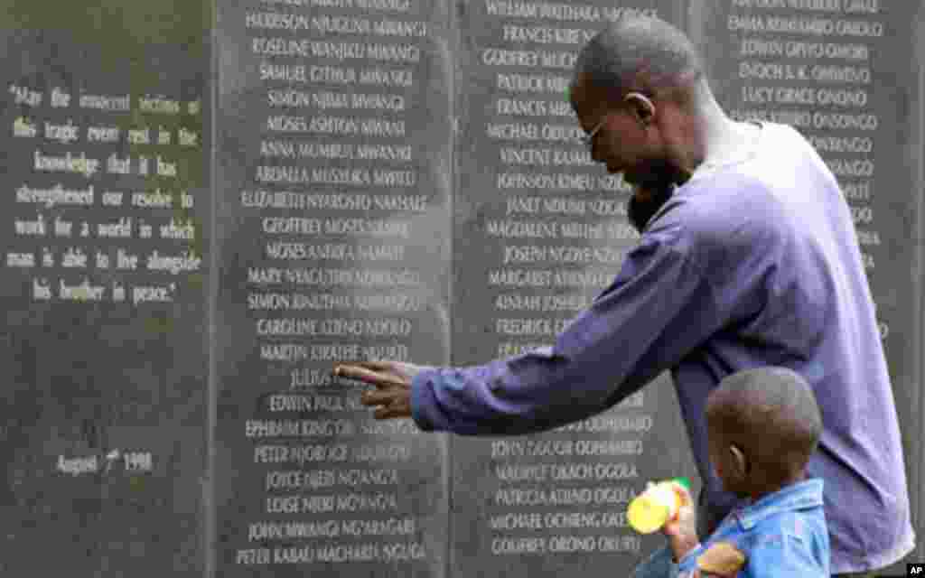 A survivor pays homage at the memorial wall with the names of 248 people killed in the 1998 bombing of the U.S.embassy are seen on the memorial wall in Nairobi (Reuters)