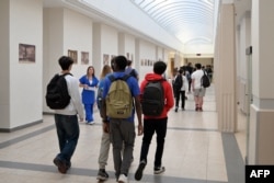 FILE - Students head to their classroom at Victor-Duruy high school on the first day of new academic year in Paris, France, Sept. 4, 2023.