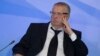 FILE - Russian lawmaker Vladimir Zhirinovsky listens to Russian President Vladimir Putin's address to members of the Crimean parliament.