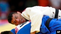 FILE - In this Aug. 30, 2018 file photo, Saeid Mollaei of Iran, top, competes against Didar Khamza of Kazakhstan during their 81kg final judo match at the 18th Asian Games in Jakarta, Indonesia. 