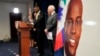An image of Haitian President Jovenel Moïse, right, is displayed as Markenzy Lapointe, U.S. Attorney for the Southern District of Florida, speaks speaks during a news conference, Feb. 14, 2023, in Miami.