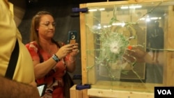 Lori Alhadeff, mother of Alyssa Alhadeff who was killed in the Parkland shooting, inspects safer window options to secure schools. (E. Sarai/VOA)