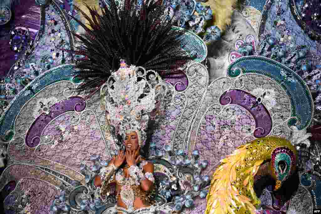 A nominee for queen of the Carnival of Santa Cruz shows off her outfit on the main stage in Santa Cruz de Tenerife on the Spanish Canary island of Tenerife, Feb. 22, 2017.