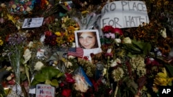 FILE - A photo of Heather Heyer, who was killed during a white nationalist rally, sits on the ground at a memorial the day her life was celebrated at the Paramount Theater in Charlottesville, Virginia.