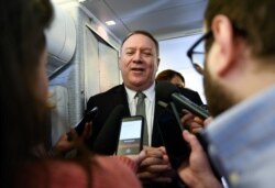 Secretary of State Mike Pompeo takes questions from reporters during a flight from Andrews Air Force Base, Md., to Germany, Feb. 13, 2020.