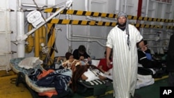 Injured men rest inside a Turkish ship carrying 250 wounded people from the besieged Libyan city of Misrata, at a port in Benghazi, April 3 2011