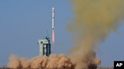 In this photo released by Xinhua News Agency, a Long March-4B rocket carrying the Fengyun-3 07 satellite blasts off from the Jiuquan Satellite Launch Center in Jiuquan, northwest China's Gansu Province, April 16, 2023.