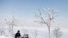 A man waits for customers at a tea stall near Qargha Lake in Kabul, Afghanistan.