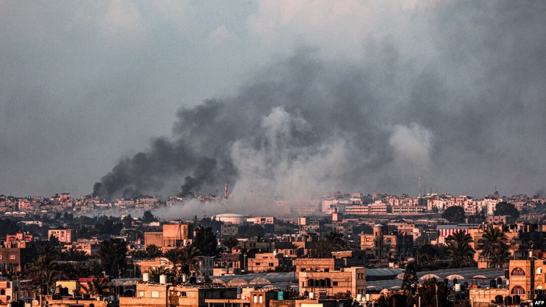 Gambar yang diambil dari Rafah menunjukkan asap mengepul di atas kota Khan Yunis di Jalur Gaza selatan selama pemboman Israel hari Minggu, 18 Februari 2024.