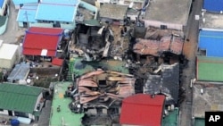 An aerial view shows destroyed houses on Yeonpyeong island, South Korea, 24 Nov 2010, one day after North Korea's artillery attack on the island.