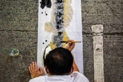An artist takes part in a performance art in Hong Kong on June 3, 2021, to mourn the victims of China's deadly Tiananmen Square crackdown after authorities banned an annual vigil.