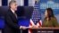 U.S. acting Secretary of Health and Human Services Eric Hargan receives a symbolic check, representing U.S. President Donald Trump's quarterly salary as a donation to the department to fight opioid epidemic, from White House Press Secretary Sarah Huckabe