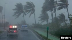 FILE - Police patrol the area as Hurricane Irma slams across islands in the northern Caribbean in San Juan, Puerto Rico, Sept. 6, 2017.