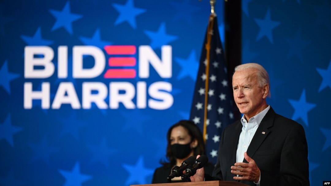 Democratic presidential candidate Joe Biden speaks as US Senator and vice presidential candidate, Kamala Harris, looks on at the Queen venue in Wilmington, Delaware, on Nov. 5, 2020.