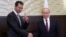 FILE - Russian President Vladimir Putin, right, shakes hands with Syrian President Bashar Assad in the Black Sea resort of Sochi, Russia, Nov. 20, 2017.