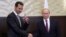 FILE - Russian President Vladimir Putin (R) shakes hands with Syrian President Bashar Assad in the Black Sea resort of Sochi, Russia, Nov. 20, 2017.