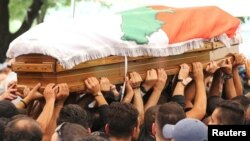 People carry the coffin of Rami Salman, one of two aides of Refugee Affairs Minister Saleh al-Gharib, who was killed in an incident that Gharib called an assassination attempt, during his funeral in Ramlieh, Lebanon, July 5, 2019.