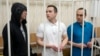 FILE - Lawyers Igor Sergunin, from left, Alexei Liptser and Vadim Kobzev, all who once represented late opposition leader Alexei Navalny, stand in a courtroom in Petushki, Vladimir region, east of Moscow, Jan. 17, 2025.