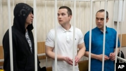 FILE - Lawyers Igor Sergunin, from left, Alexei Liptser and Vadim Kobzev, all who once represented late opposition leader Alexei Navalny, stand in a courtroom in Petushki, Vladimir region, east of Moscow, Jan. 17, 2025.