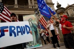 Protesters rally outside the State Capitol building after former Vice President Joe Biden was declared the winner of the 2020 U.S. presidential election, in Lansing, Michigan, Nov. 8, 2020.