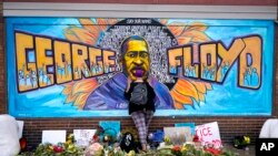 FILE: A mural at George Floyd Square in Minneapolis, April 23, 2021. The area has become a protest site since Floyd, a Black man, was killed there by white police officer Derek Chauvin on May 2020, sparking a national reckoning on racial injustice. 