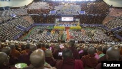 Hardline Buddhist monks and supporters celebrate the recent establishment of four controversial bills decried by rights groups as aimed at discriminating against the country's Muslim minority, with a rally in a stadium at Yangon October 4, 2015. REUTERS/S